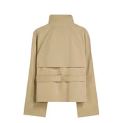 trench coat for women with a structured fit, high collar and dark buttons. Crafted from premium fabric, it highlights the waist and adds refined elegance to any autumn or winter outfit.