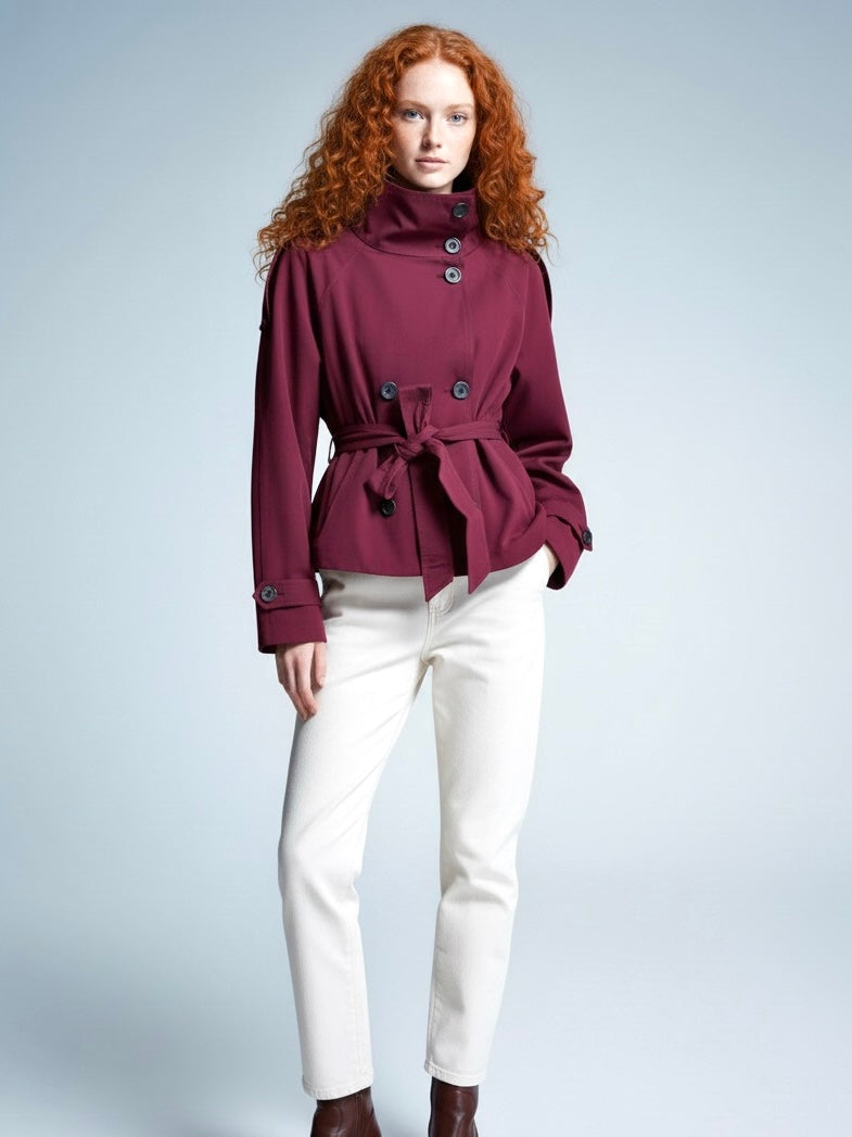 Beige Cath trench coat for women with a structured fit, high collar and dark buttons. Crafted from premium fabric, it highlights the waist and adds refined elegance to any autumn or winter outfit.