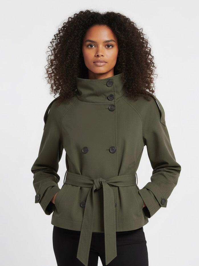Beige Cath trench coat for women with a structured fit, high collar and dark buttons. Crafted from premium fabric, it highlights the waist and adds refined elegance to any autumn or winter outfit.