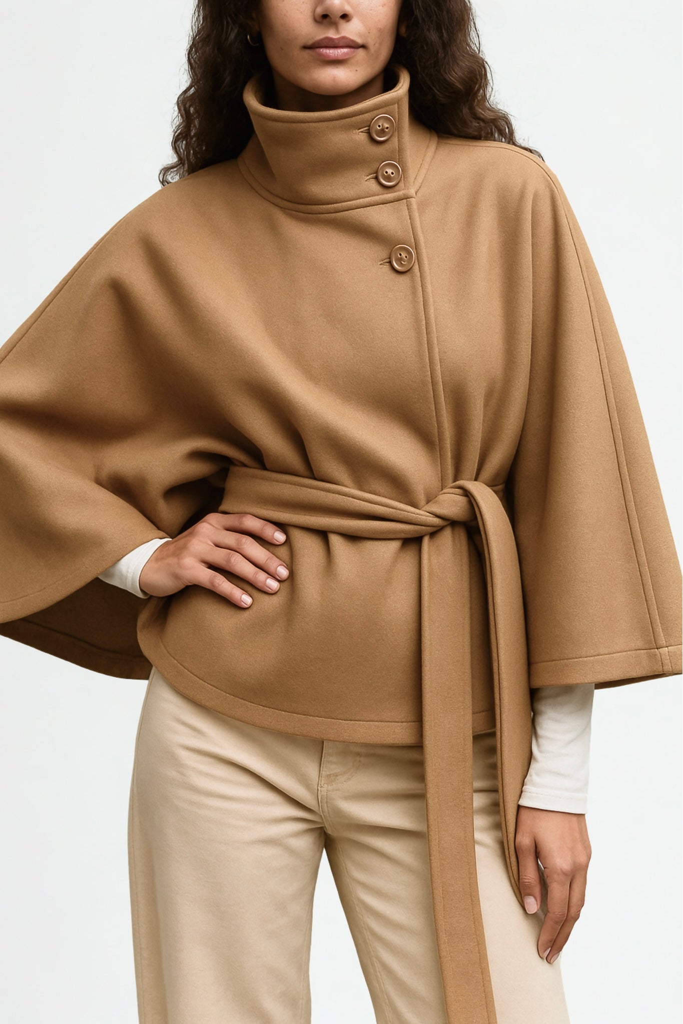 winter coat with high-neck collar, cape silhouette and adjustable waist belt. A chic belted jacket combining elegance, comfort and versatile seasonal style.
