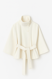 High-Neck Belted Cape Jacket in camel wool blend. Poncho-inspired autumn/winter coat with high-neck collar, cape silhouette and adjustable waist belt. A chic belted jacket combining elegance, comfort and versatile seasonal style.