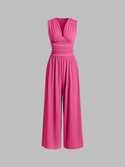 Pink sleeveless jumpsuit with deep V neckline, ruched waist and wide-leg trousers