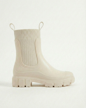 White waterproof ankle boot with elastic side panels, pull tabs and chunky lug sole