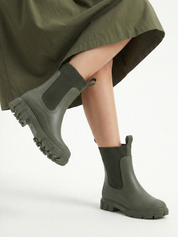 Green waterproof ankle boot with elastic side panels, pull tabs and chunky lug sole