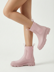 Pink waterproof ankle boot with elastic side panels, pull tabs and chunky lug sole