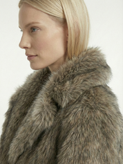 Long faux fur coat in deep brown tones with wide lapel collar and full-length silhouette