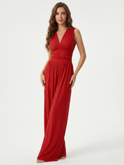 Red sleeveless jumpsuit with deep V neckline, ruched waist and wide-leg trousers