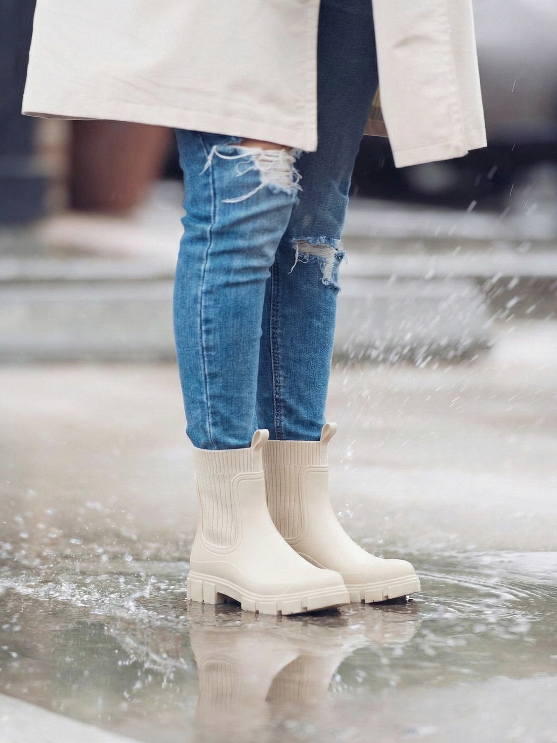 White waterproof ankle boot with elastic side panels, pull tabs and chunky lug sole
