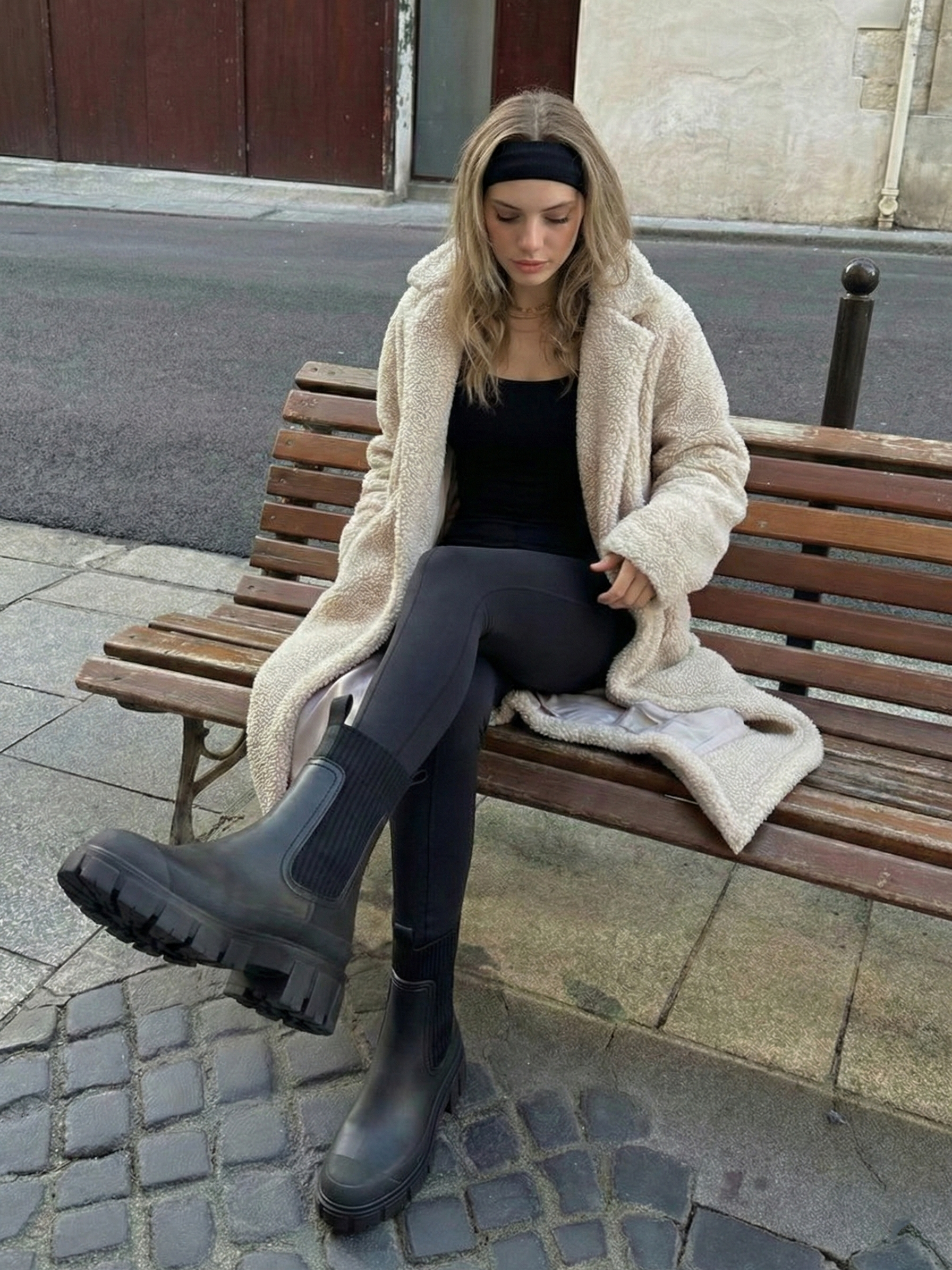 Black waterproof ankle boot with elastic side panels, pull tabs and chunky lug sole