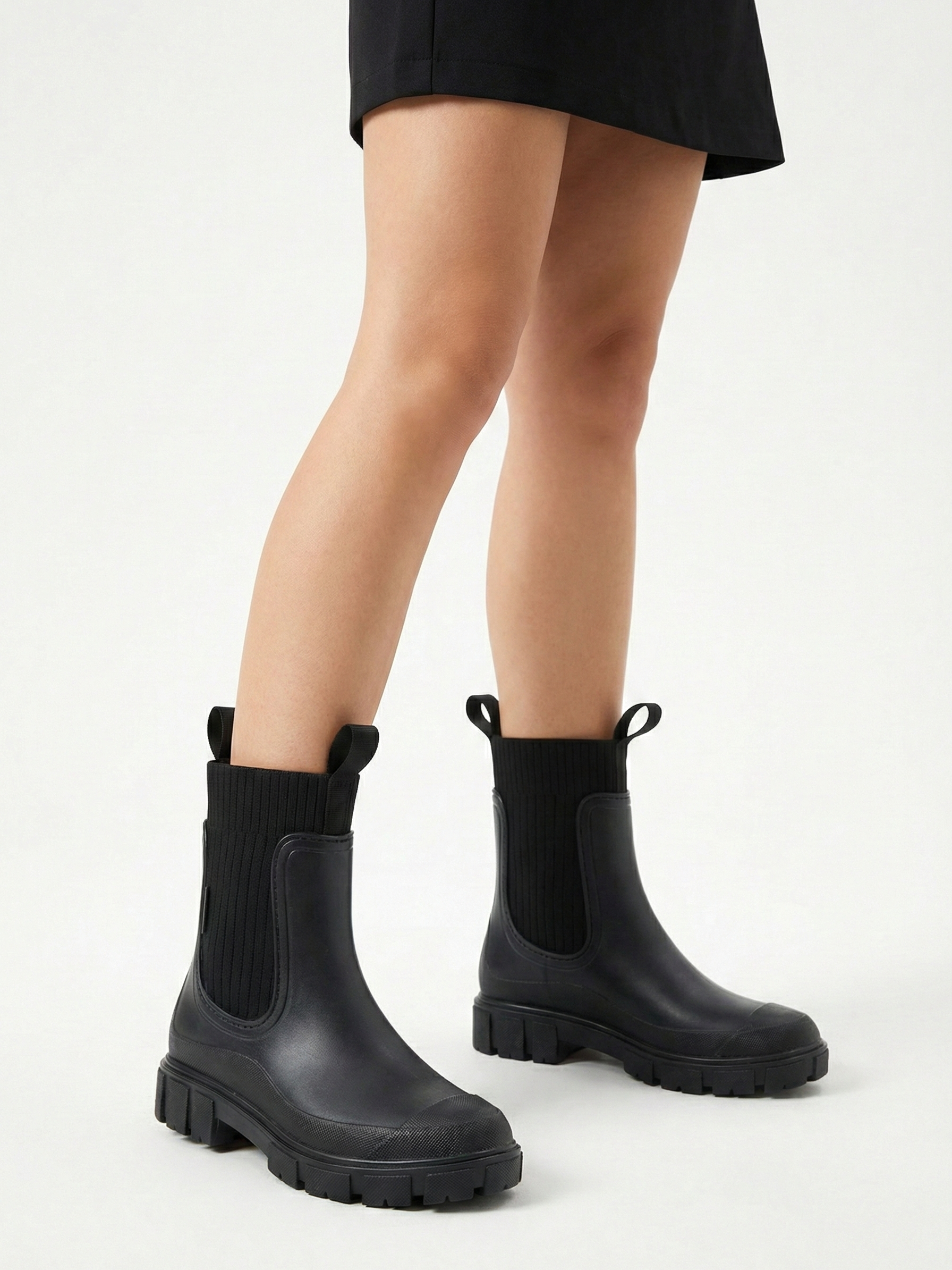 Black waterproof ankle boot with elastic side panels, pull tabs and chunky lug sole