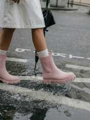 Pink waterproof ankle boot with elastic side panels, pull tabs and chunky lug sole