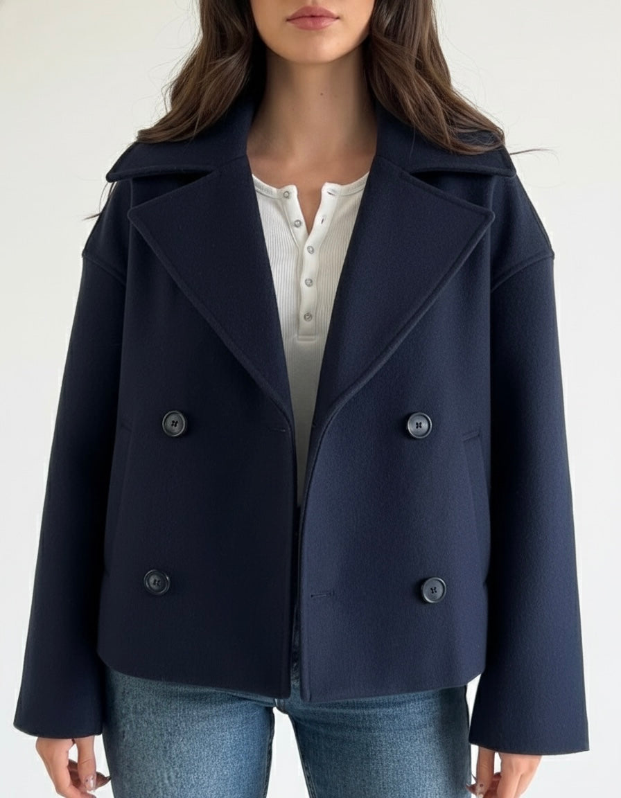 Wool Blend Double-Breasted Trench Coat for women. Features wide lapels, double front button fastening and structured tailoring. Ideal outerwear for autumn and winter layering with a refined, minimalist fit.