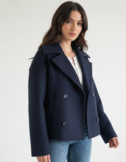 Wool Blend Double-Breasted Trench Coat for women. Features wide lapels, double front button fastening and structured tailoring. Ideal outerwear for autumn and winter layering with a refined, minimalist fit.