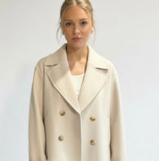Wool Blend Double-Breasted Trench Coat for women. Features wide lapels, double front button fastening and structured tailoring. Ideal outerwear for autumn and winter layering with a refined, minimalist fit.