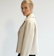 Wool Blend Double-Breasted Trench Coat for women. Features wide lapels, double front button fastening and structured tailoring. Ideal outerwear for autumn and winter layering with a refined, minimalist fit.