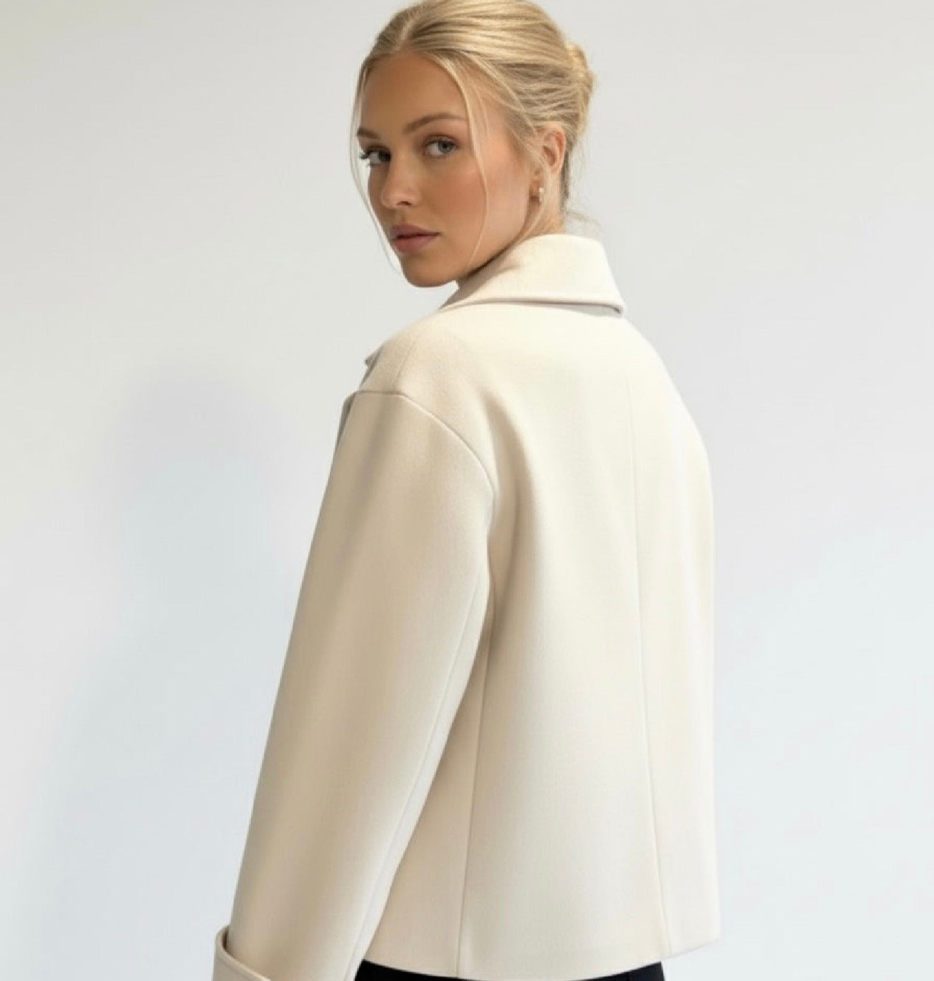 Wool Blend Double-Breasted Trench Coat for women. Features wide lapels, double front button fastening and structured tailoring. Ideal outerwear for autumn and winter layering with a refined, minimalist fit.
