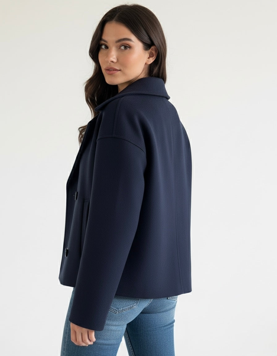 Wool Blend Double-Breasted Trench Coat for women. Features wide lapels, double front button fastening and structured tailoring. Ideal outerwear for autumn and winter layering with a refined, minimalist fit.