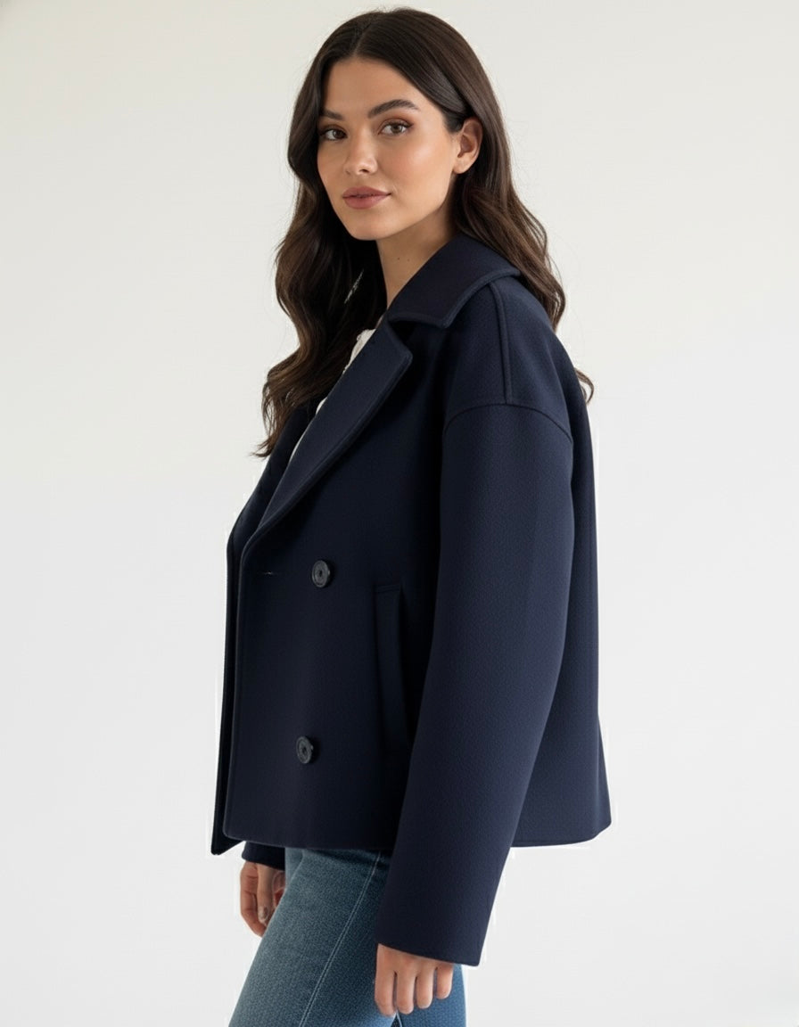 Wool Blend Double-Breasted Trench Coat for women. Features wide lapels, double front button fastening and structured tailoring. Ideal outerwear for autumn and winter layering with a refined, minimalist fit.