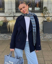 Wool Blend Double-Breasted Trench Coat for women. Features wide lapels, double front button fastening and structured tailoring. Ideal outerwear for autumn and winter layering with a refined, minimalist fit.