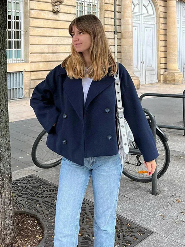 Wool Blend Double-Breasted Trench Coat for women. Features wide lapels, double front button fastening and structured tailoring. Ideal outerwear for autumn and winter layering with a refined, minimalist fit.